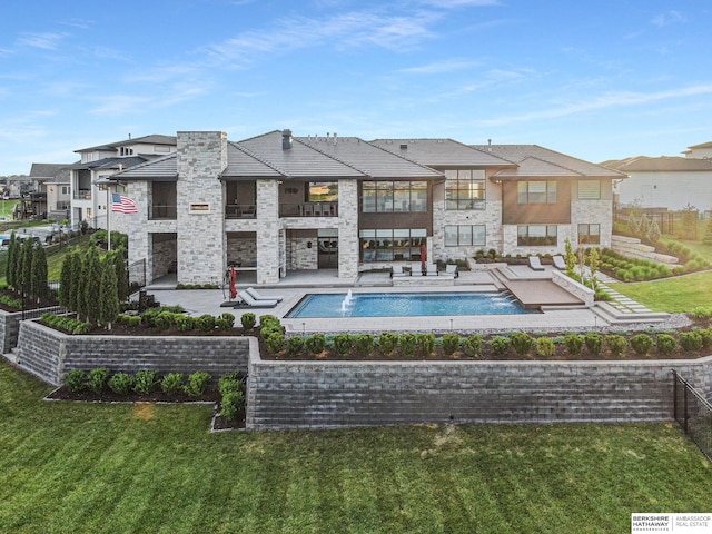 view of pool with a yard, fence, and a residential view