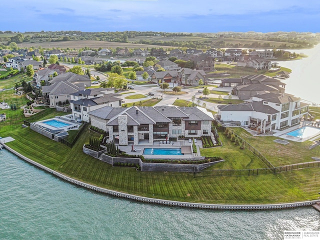 birds eye view of property featuring a water view and a residential view