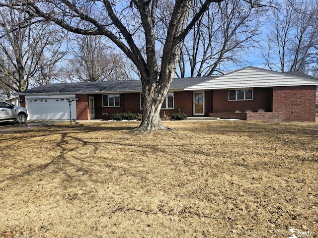 504 N Plum St, Shickley, NE 68436 - ranch-style home featuring a garage, brick siding, and driveway
