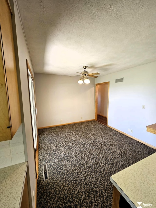 504 N Plum St, Shickley, NE 68436 - empty room with ceiling fan, baseboards, and a textured ceiling