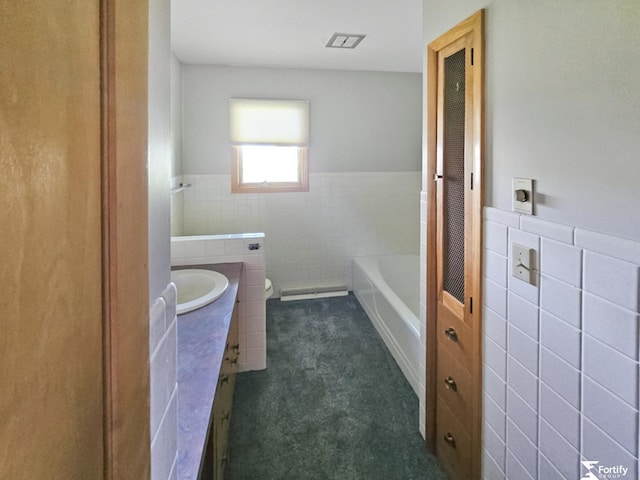 504 N Plum St, Shickley, NE 68436 - full bath with tile walls, toilet, vanity, wainscoting, and a bath