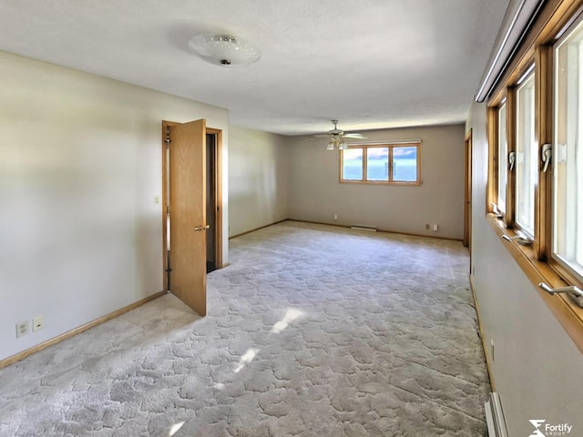 504 N Plum St, Shickley, NE 68436 - empty room featuring a ceiling fan, light carpet, and baseboards