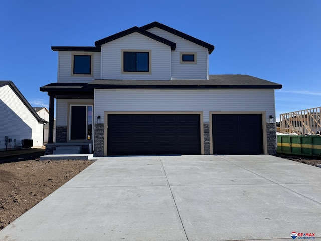 view of front of home with stone siding and driveway