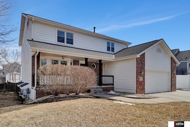 view of front facade featuring brick siding, an attached garage, a front yard, fence, and driveway