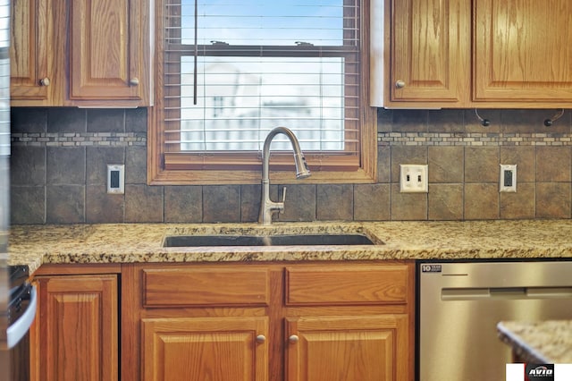 kitchen featuring light stone counters, a sink, range, decorative backsplash, and dishwasher