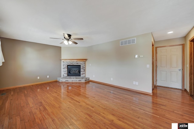 unfurnished living room featuring ceiling fan, light wood-style flooring, visible vents, and baseboards