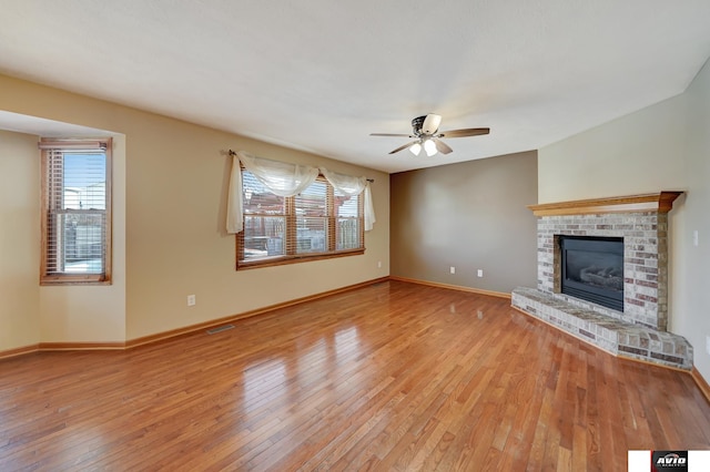 unfurnished living room with a healthy amount of sunlight, visible vents, baseboards, and light wood finished floors