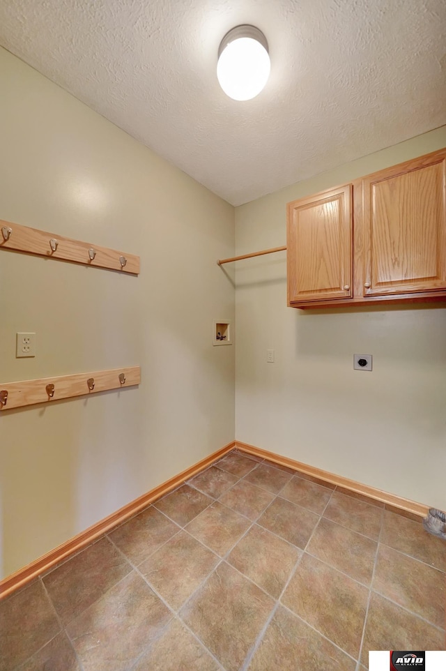 washroom with baseboards, a textured ceiling, washer hookup, and hookup for an electric dryer