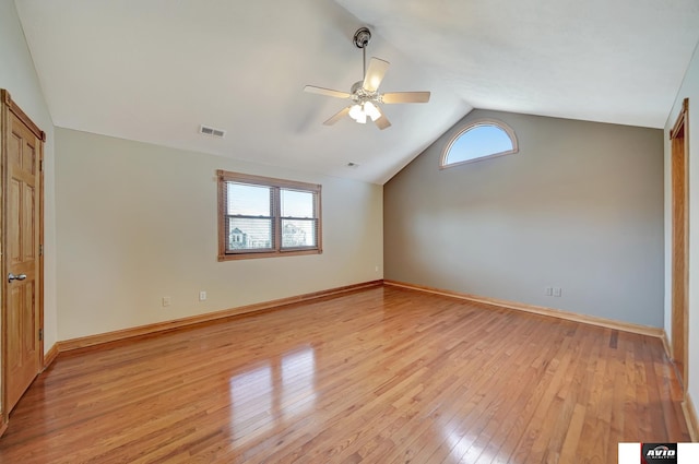 interior space featuring lofted ceiling, baseboards, visible vents, and light wood finished floors