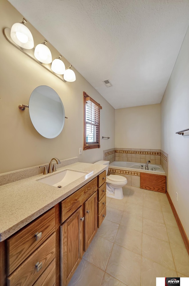 bathroom with visible vents, toilet, vanity, a textured ceiling, and tiled tub