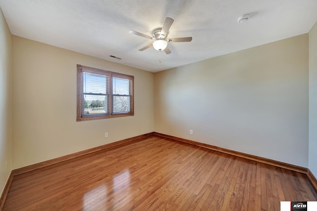 unfurnished room with visible vents, ceiling fan, light wood-style flooring, and baseboards