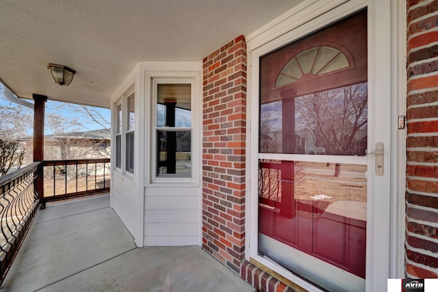 view of exterior entry with brick siding