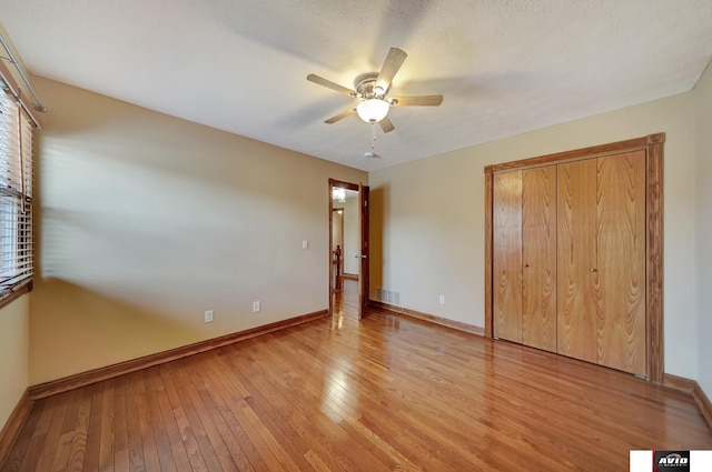 unfurnished bedroom featuring light wood-style floors, baseboards, visible vents, and a ceiling fan