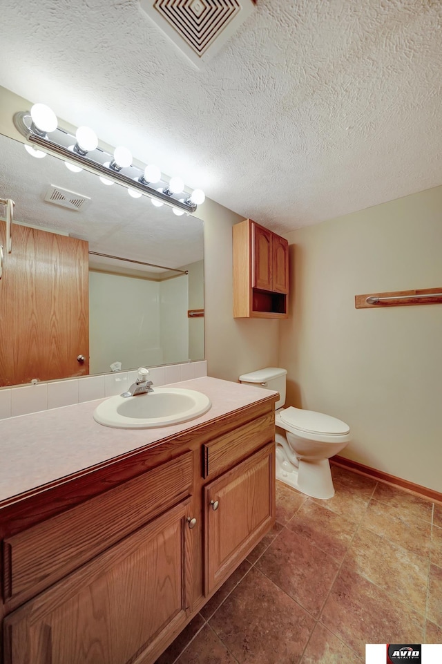 full bathroom with visible vents, vanity, toilet, and a textured ceiling