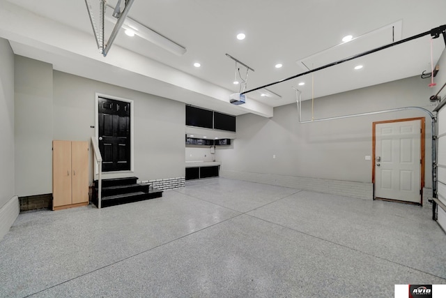 garage featuring recessed lighting and a garage door opener