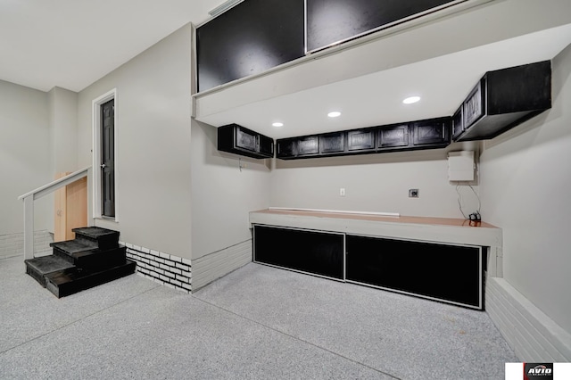 kitchen with light speckled floor, light countertops, dark cabinetry, and recessed lighting