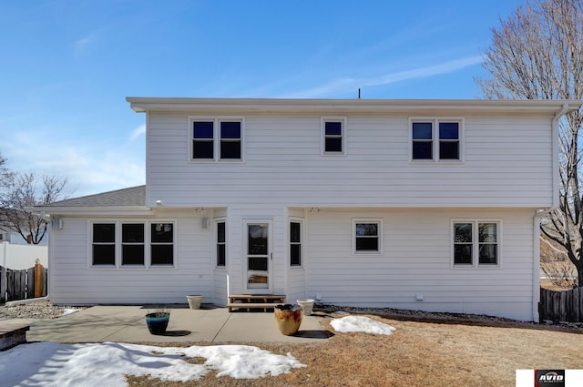 rear view of property featuring entry steps, a patio area, fence, and roof with shingles