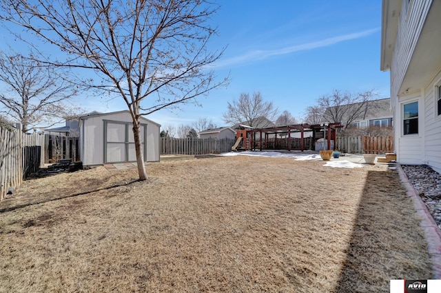 view of yard with an outbuilding, a shed, a fenced backyard, and a pergola