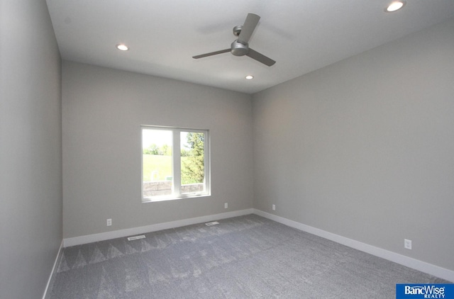 carpeted spare room featuring a ceiling fan, recessed lighting, and baseboards