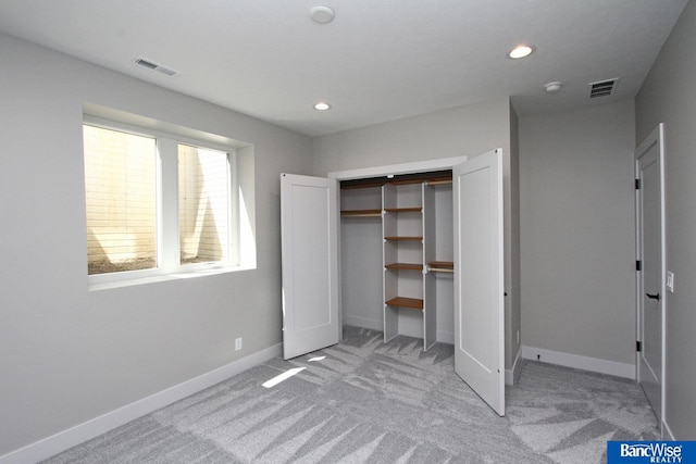 unfurnished bedroom with recessed lighting, carpet flooring, visible vents, and baseboards