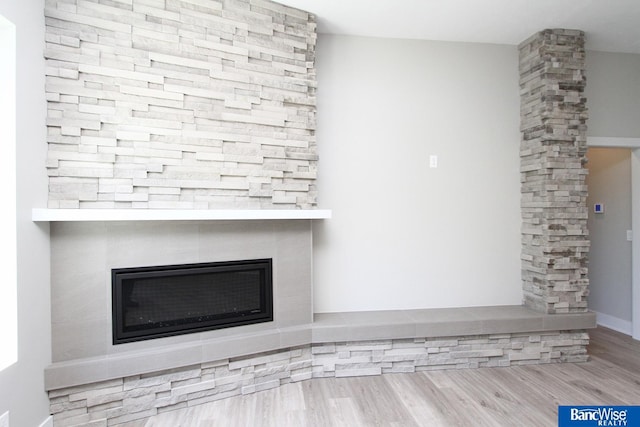 interior details with a fireplace and wood finished floors