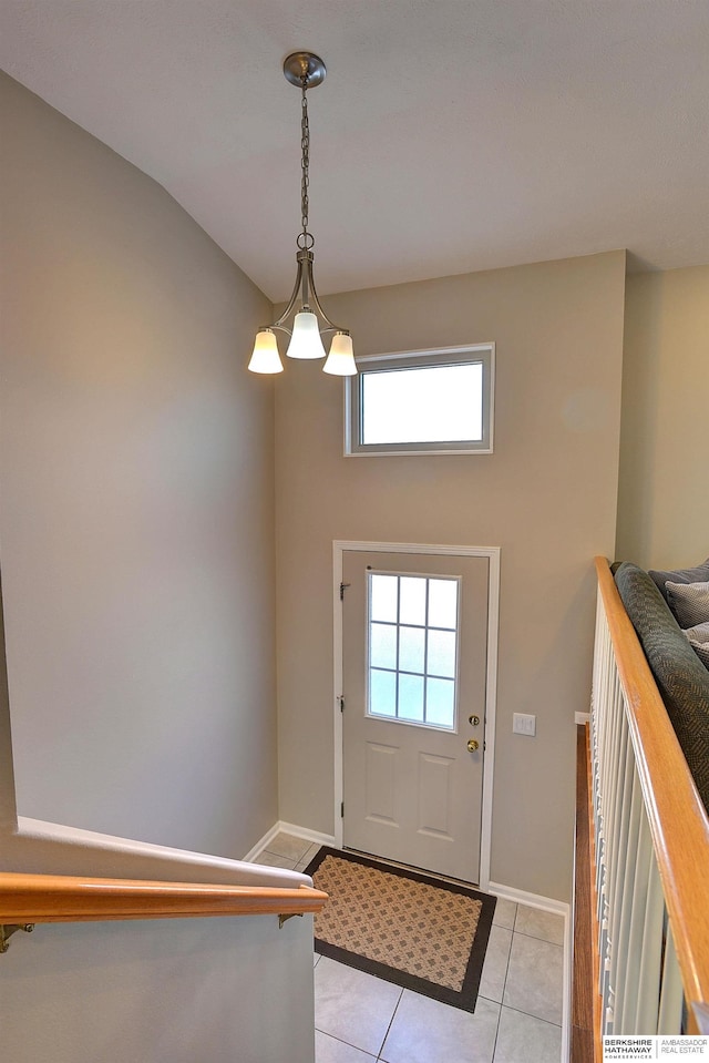 foyer with light tile patterned flooring and baseboards