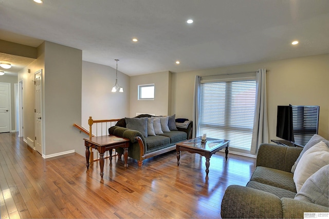 living room with recessed lighting, baseboards, and wood-type flooring