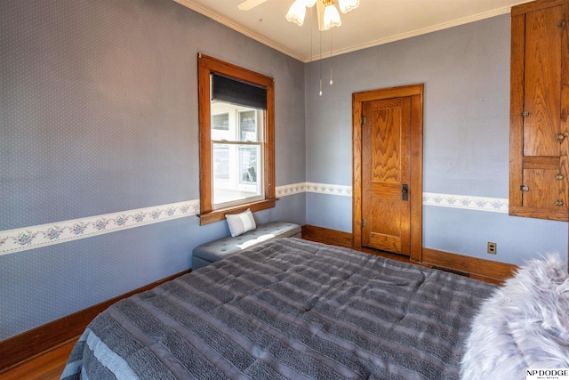 bedroom with baseboards, crown molding, dark wood finished floors, and wallpapered walls