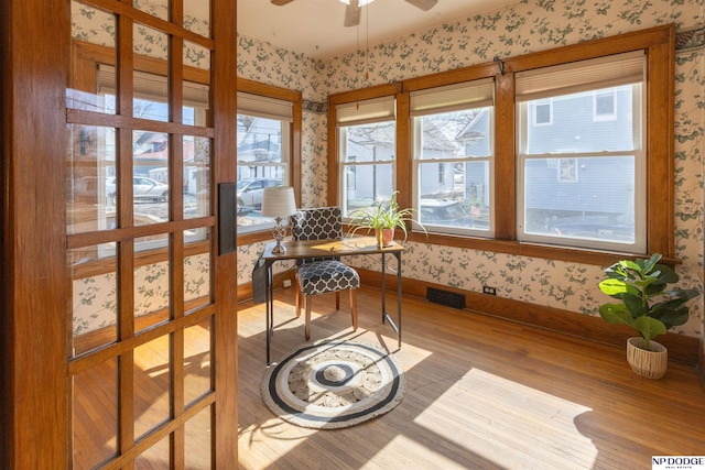 sunroom / solarium featuring ceiling fan