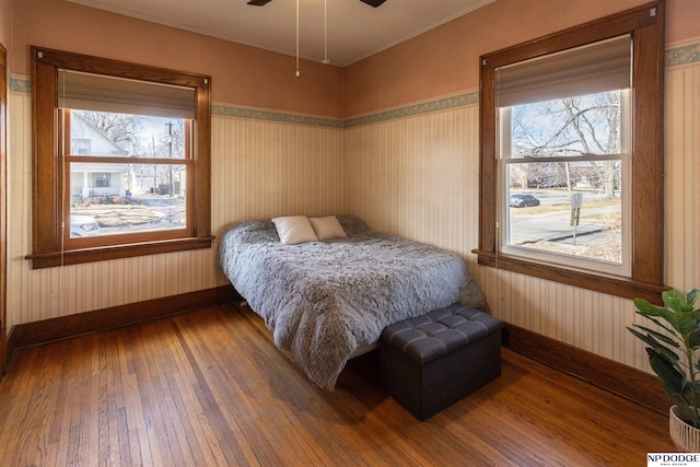 bedroom with hardwood / wood-style flooring and baseboards