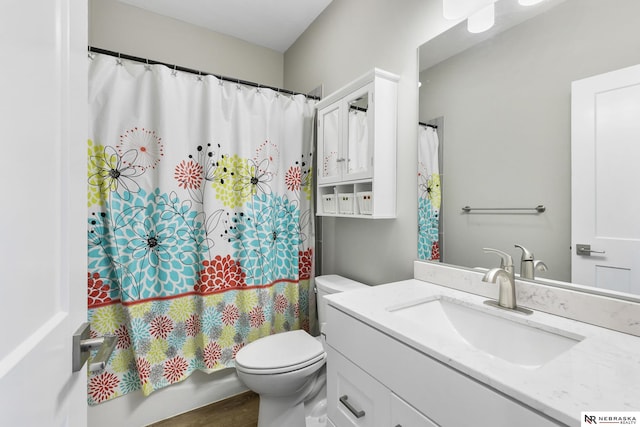 bathroom featuring toilet and vanity