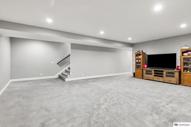 unfurnished living room featuring baseboards, stairway, carpet, and recessed lighting