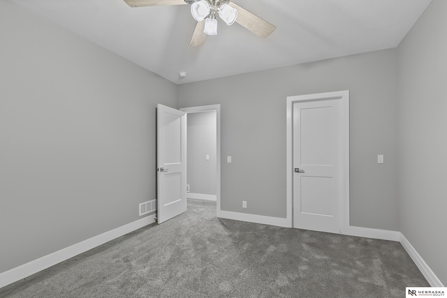 unfurnished bedroom with ceiling fan, carpet, visible vents, and baseboards