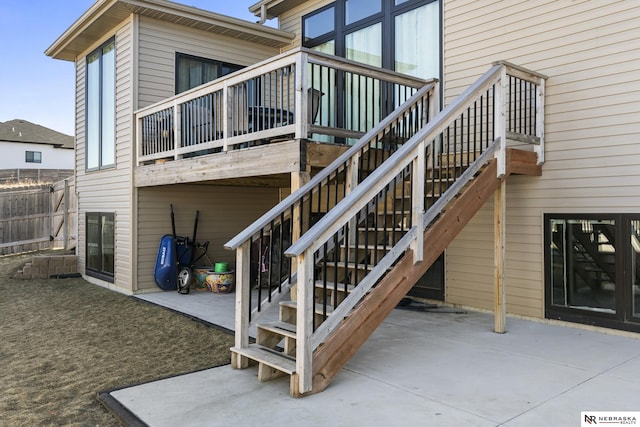 rear view of property with stairway and a patio