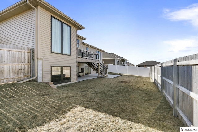 back of house featuring a patio, a fenced backyard, a yard, stairway, and a wooden deck