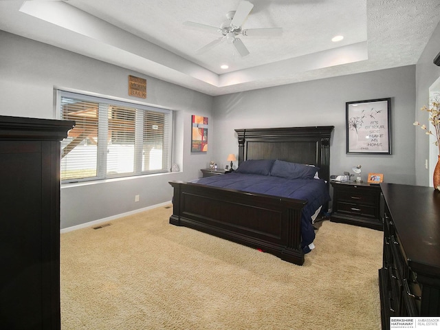 bedroom featuring carpet, baseboards, a tray ceiling, and recessed lighting