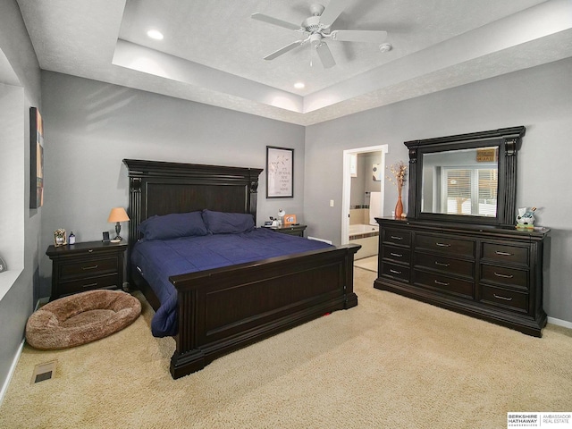 bedroom featuring a tray ceiling, light carpet, and recessed lighting