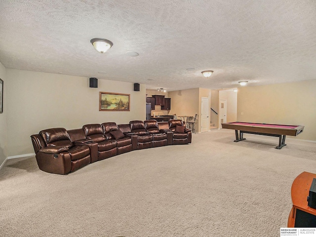 carpeted home theater room featuring baseboards and a textured ceiling