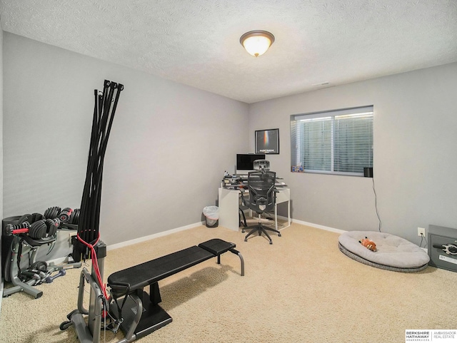 office area with carpet floors, visible vents, a textured ceiling, and baseboards