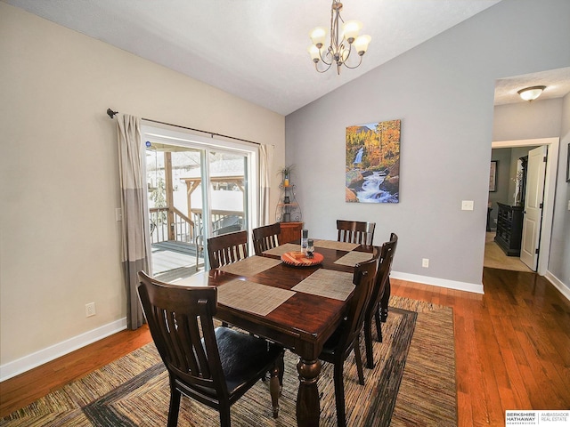 dining area featuring vaulted ceiling, dark wood-style flooring, baseboards, and a notable chandelier