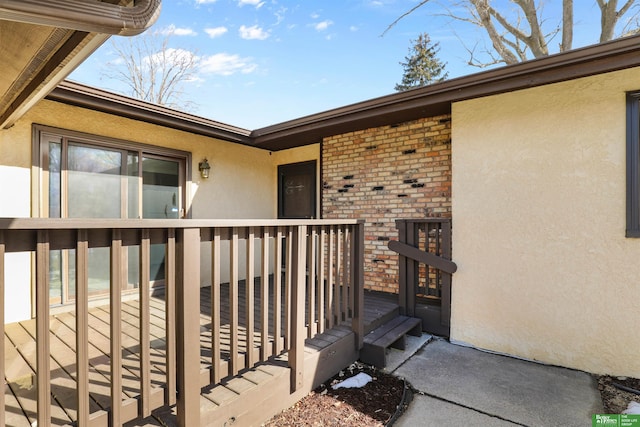 property entrance featuring brick siding and stucco siding