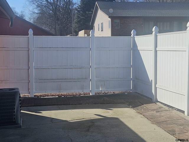 exterior space with central AC and fence