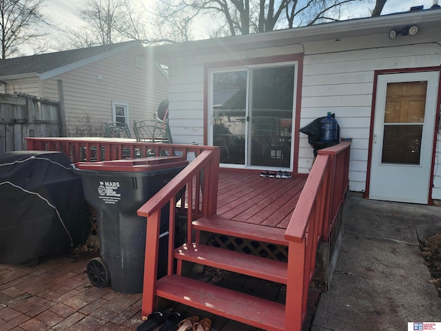 wooden deck with a grill