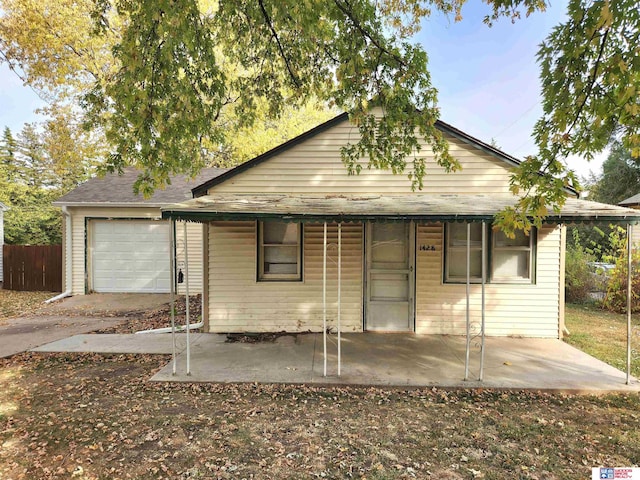 view of front of house with a garage and fence