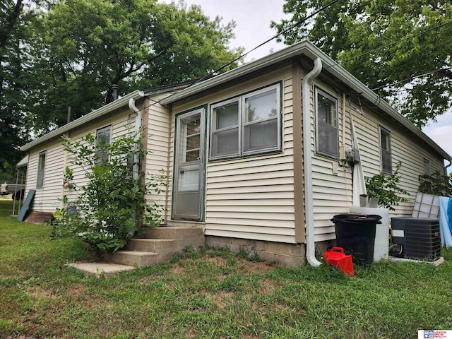 exterior space featuring a front yard and central AC unit