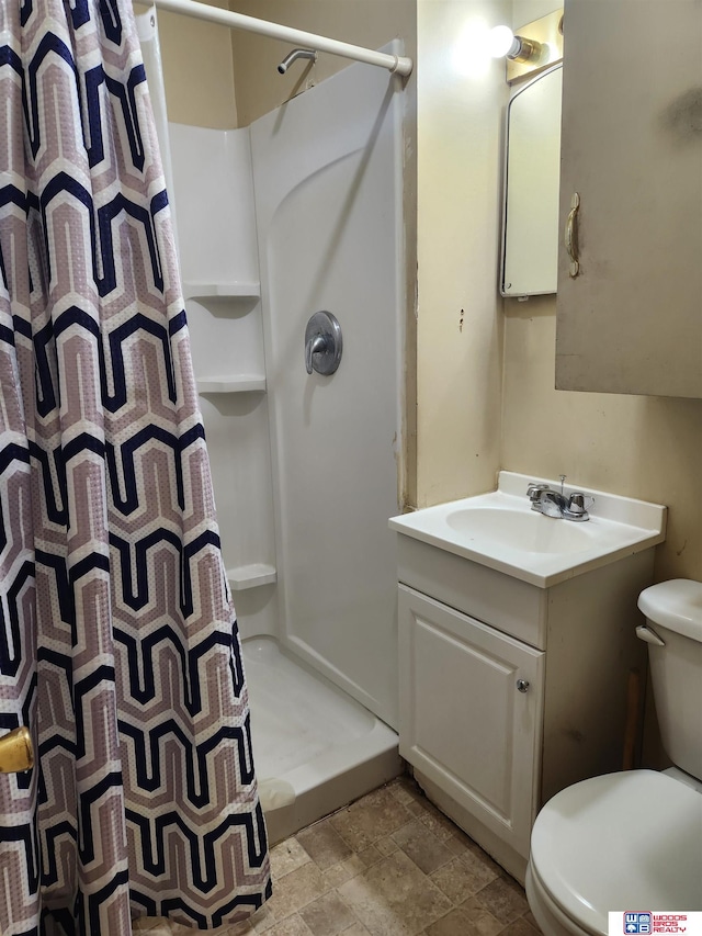 full bathroom with toilet, stone finish floor, a shower stall, and vanity