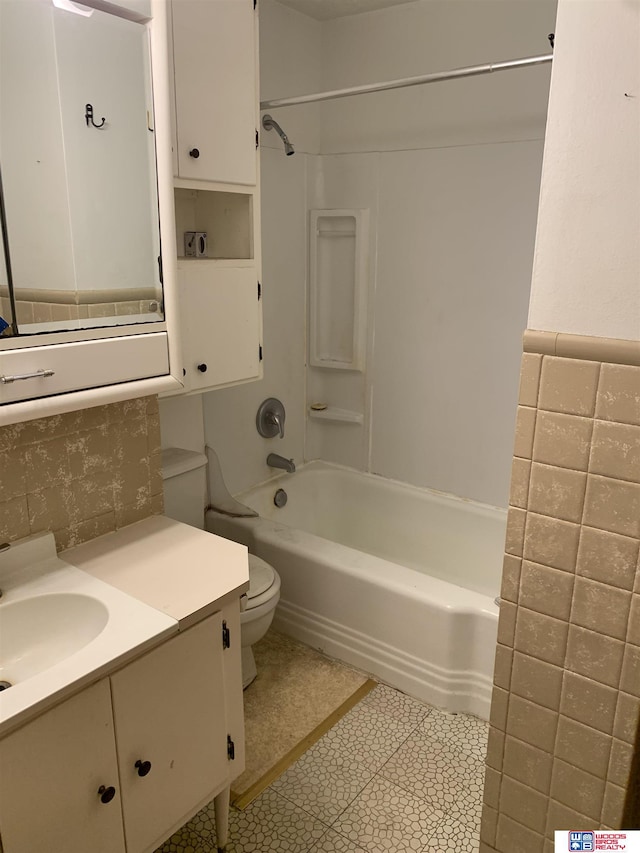 bathroom featuring shower / washtub combination, vanity, and toilet