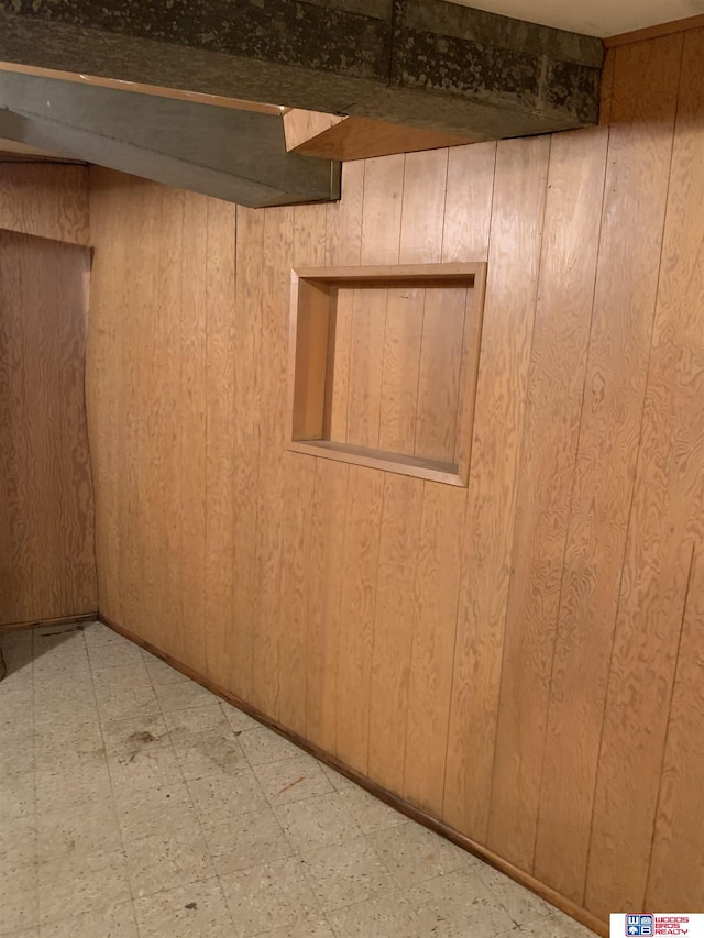 finished basement with light floors and wooden walls