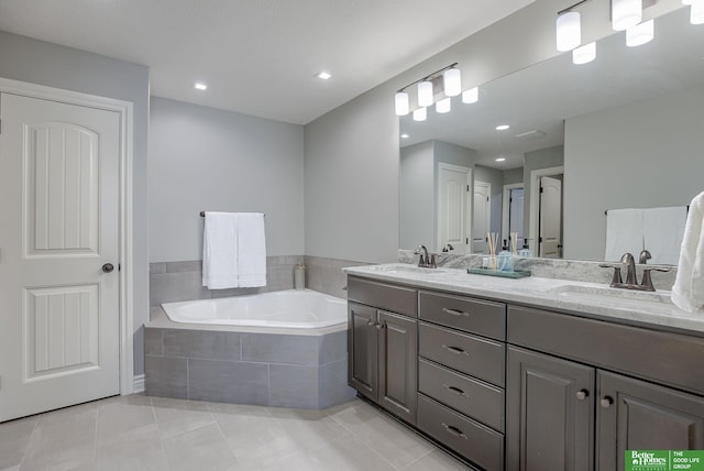 bathroom featuring a sink, a garden tub, double vanity, and tile patterned floors