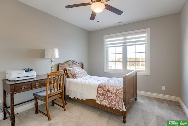 bedroom featuring a ceiling fan, baseboards, visible vents, and light carpet